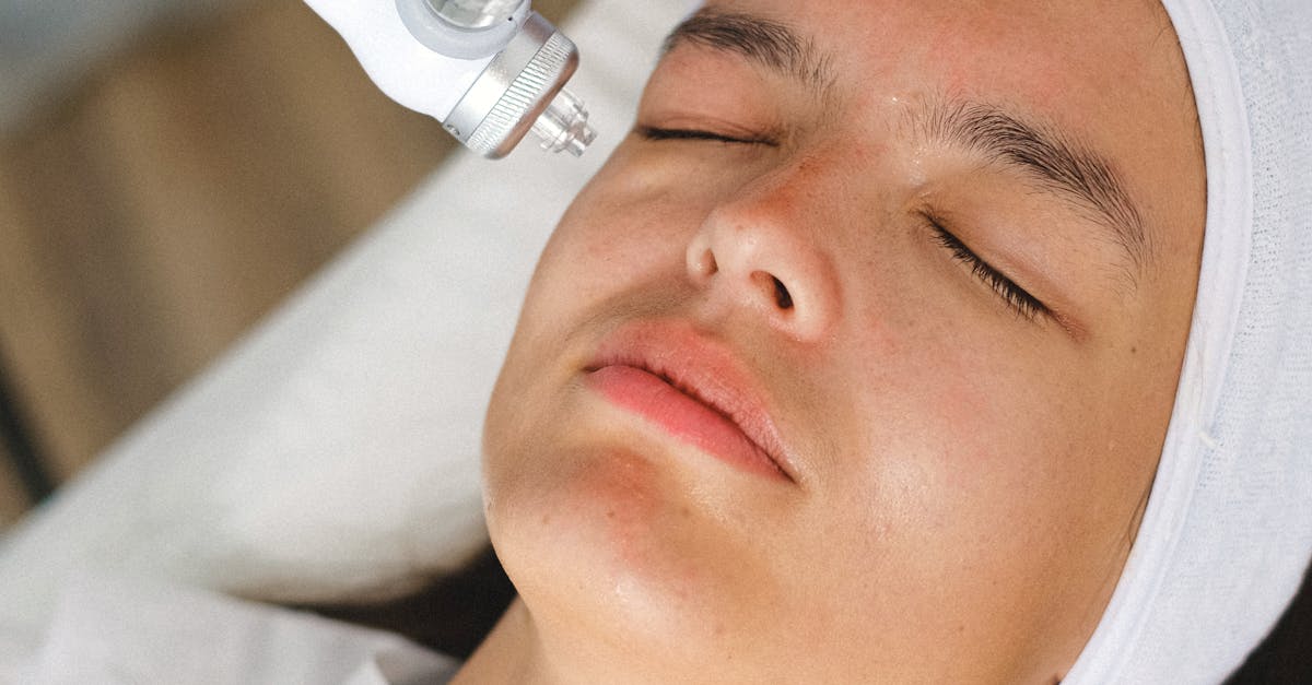 A client receiving a facial skincare treatment at a spa by a professional beautician using advanced equipment.